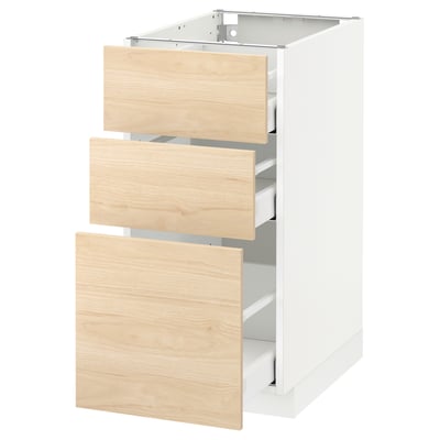 A white and light wood kitchen cabinet set with three drawers partially open, showcasing a modern minimalist design.