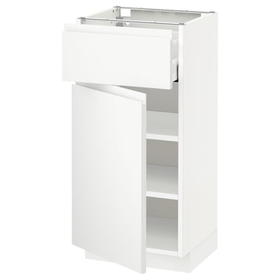 A white METOD kitchen cabinet with a single drawer and an open compartment, featuring minimalist design.