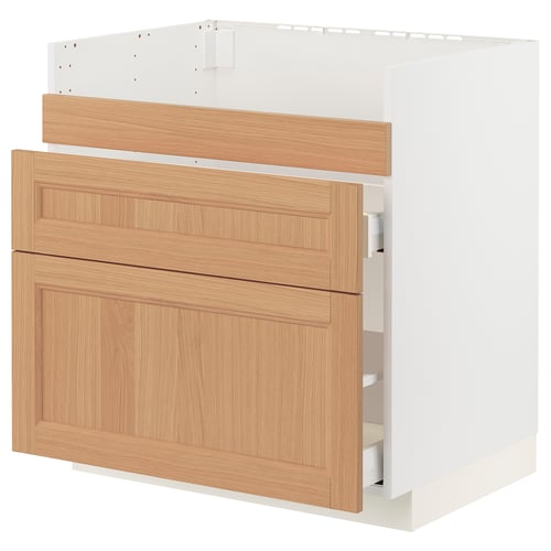 An ikea METOD kitchen cabinet with oak drawer fronts. It has a white base and three wooden drawers.