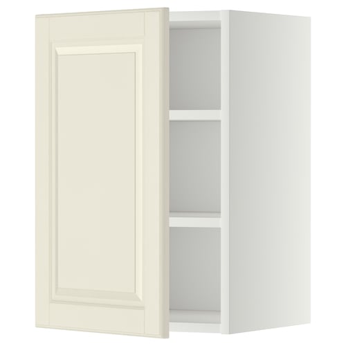 An off-white wall cabinet from the METOD kitchen system. It has a door with bevelled edges, adjustable shelves, and a rectangular shape.