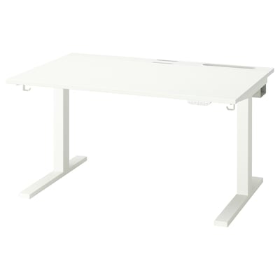A white MITTZON sit/stand desk with a rectangular shape and metal legs. It includes cable management and a control panel for height adjustment.