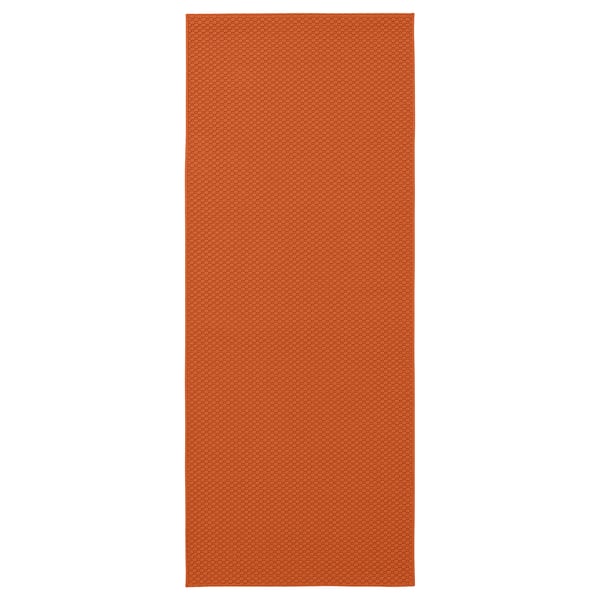 Orange rectangular rug with subtle textured pattern.