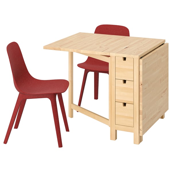 A compact dining set includes a light wooden drop-leaf table and two red chairs with red legs.