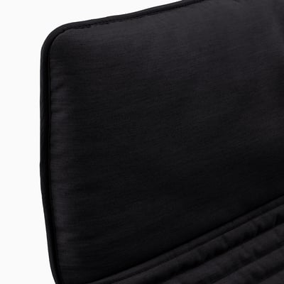 Black cushioned chair, smooth fabric, rectangular shape, neatly stitched edges, appears comfortable and well-crafted.