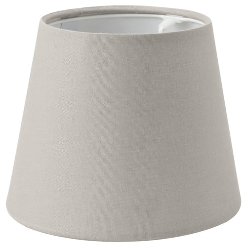 A SKOTTORP beige lamp shade. Its made of textile with a classic design. The shade is conical and diffuses light softly.