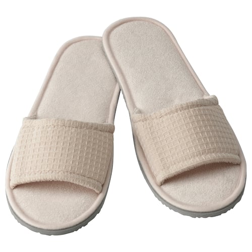 A pair of beige SKOVELSJÖN slippers, featuring soft waffle texture, comfy eva foam soles, and open-toe design.