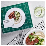 Škatla za rastlinski obrok LÄTTLAGAT podjetja IKEA, ki prikazuje zamrznjen obrok, pripravljen krožnik in rezine kumare.