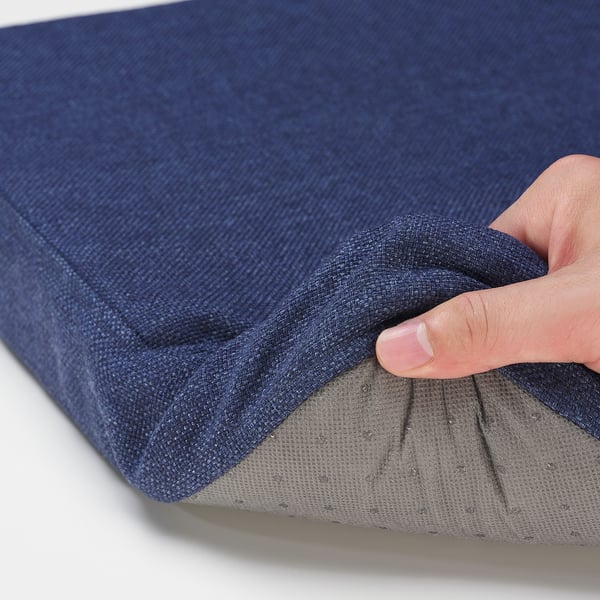 Tight grasp on soft, blue cushion; quality material and sturdy craft.