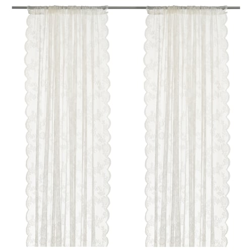 ALVINE SPETS sheer white curtains with lace design and curved edges.