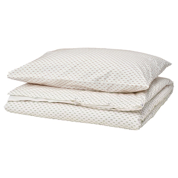 A neatly folded white BANDKNIPPE duvet cover set with beige woven details, made from 100% cotton.