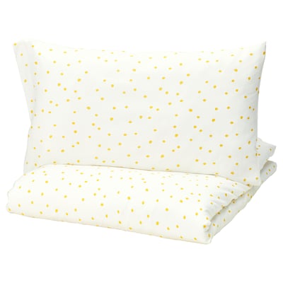 Barndrom pillow, yellow dots on white, rectangular shape.