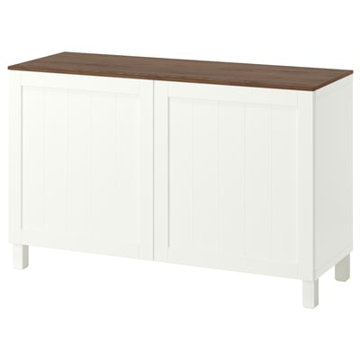 White BESTÅ sideboard with wooden top, shaker-style design, adjustable shelves, four legs.