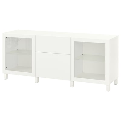 A white BESTÅ sideboard with glass doors and shelves. It has a modern design with clean lines and adjustable interiors for versatile storage.