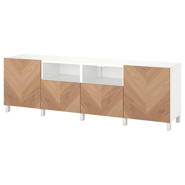 White BESTÅ tv bench with wood grain doors, adjustable shelves, and cable management.