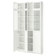 A white BILLY bookcase with glass doors and adjustable shelves.