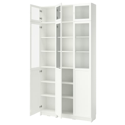 A white BILLY bookcase with glass doors and adjustable shelves.