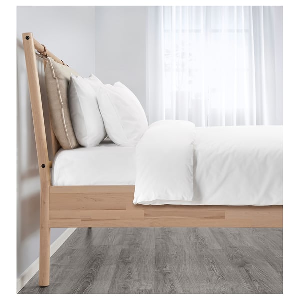 Adjustable wooden bed frame with white mattress and pillows against a window.