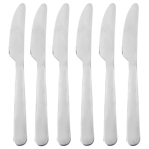 Six silver knives stand upright, clean and ready for use. Stainless steel, durable.
