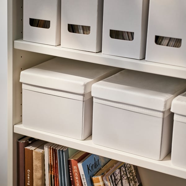 Shelf with storage boxes and books. Fabric boxes fit in billy bookcase, organising items neatly.