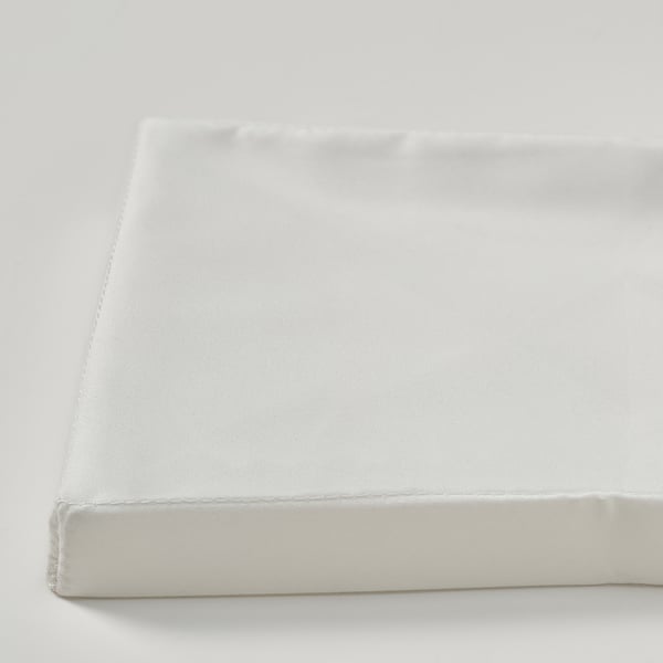 Close-up of white, neatly folded, soft fabric lid.