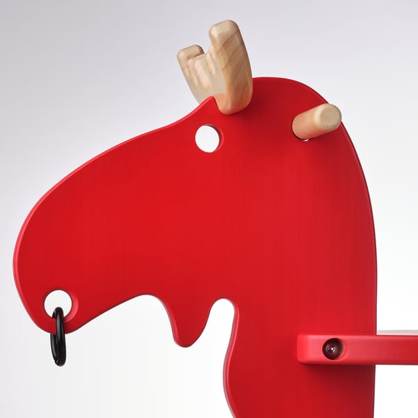 Red wooden rocking horse with handles.