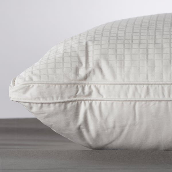 Close-up of a high-quality pillow with soft, quilted texture, showing detailed stitching and plump fill.