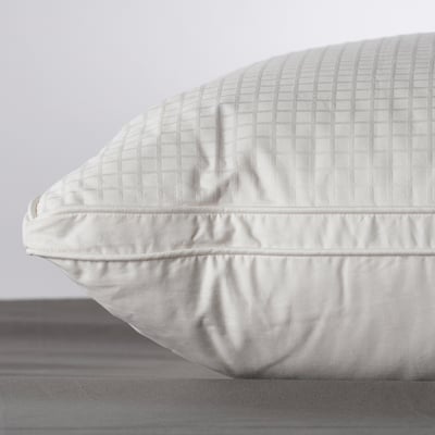 Close-up of a high-quality pillow with soft, quilted texture, showing detailed stitching and plump fill.