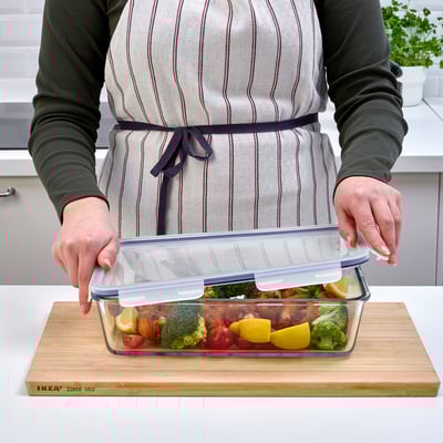 An IKEA 365+ clear glass food container with a locking lid, designed for storing and transporting meals.
