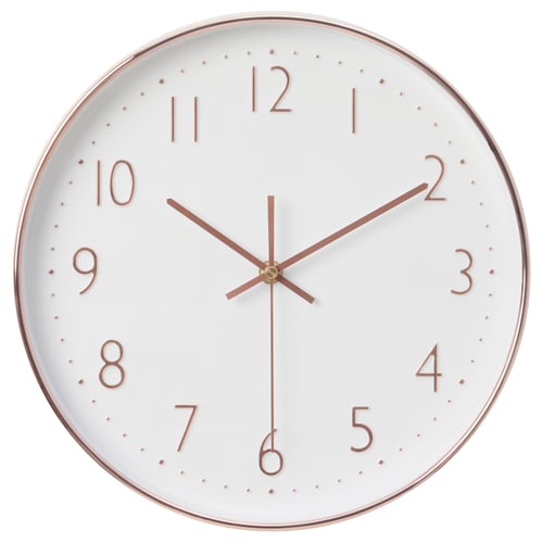 Round white clock with copper numbers and hands, silent quartz movement.