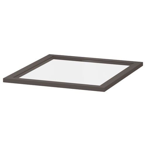 A KOMPLEMENT glass shelf in dark grey. Its square-shaped with a fiberboard frame and tempered glass.