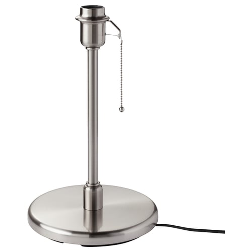 A kryssma stainless steel lamp base. Its metallic, cylindrical, with a pull chain switch. It stands on a round base.