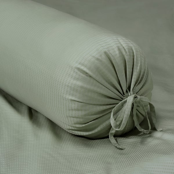 Green pillow with textured fabric and removable cover.