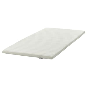 A white NISSEHOLM firm mattress pad, rectangular, with a textured surface and removable cover.