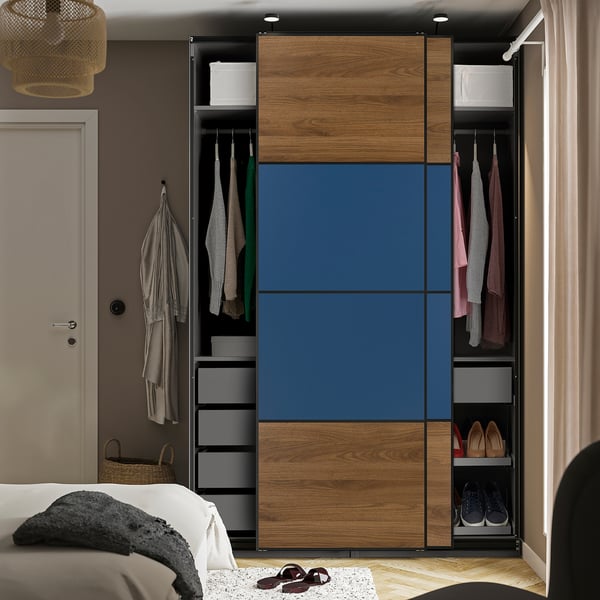 Modern wardrobe with sliding doors featuring hanging clothes, shelves, and shoe storage.