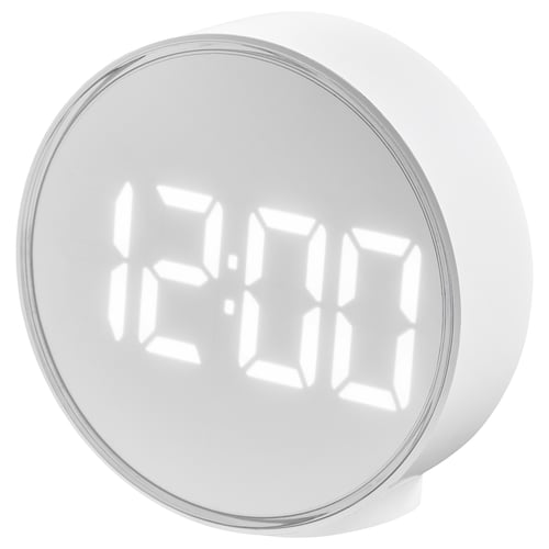 A round white digital alarm clock, modern with clear digits, adjustable brightness, and a wake-up signal feature.