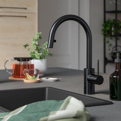 Black SALLSJÖN kitchen tap with curved spout, hidden spray, and stainless steel body.