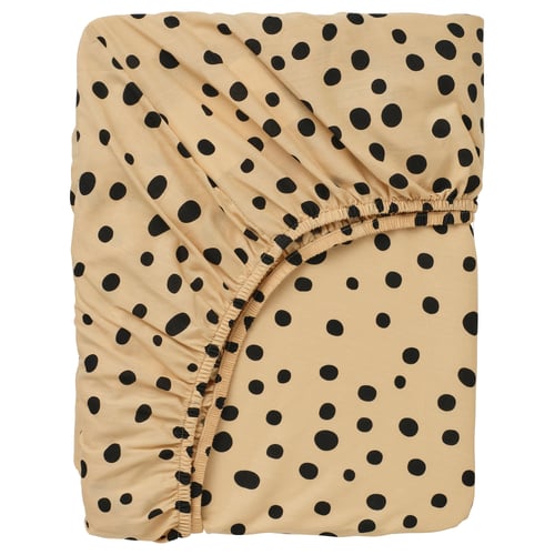 A SANDLÖPARE fitted sheet with a beige and black polka-dot pattern. It has elastic edges for a secure fit.