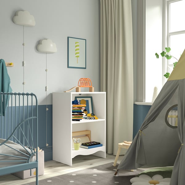 Childs room with white SMÅGÖRA changing table, blue crib, & grey tent. Decorative cloud lights & bookshelf with toys.