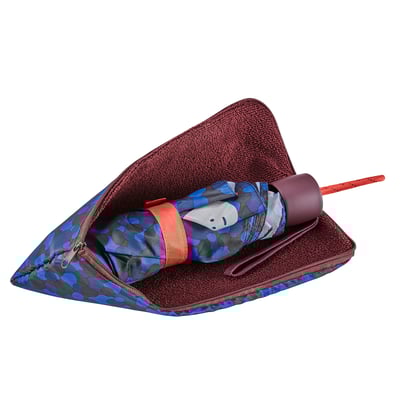 Compact umbrella with patterned fabric in case, ready for travel.