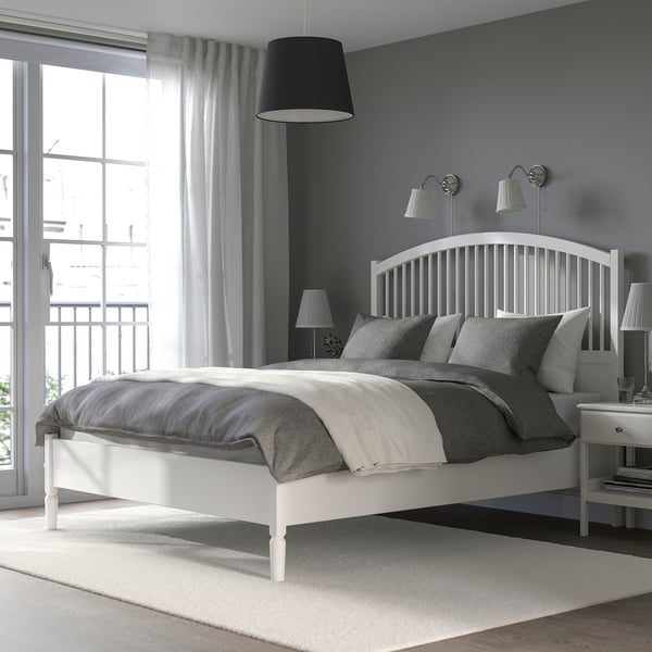 TYSSEDAL white bed, grey linens, high headboard, large, clean, neat, with spindle design.