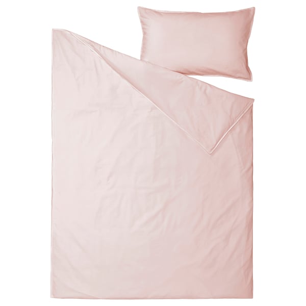 Blush pink bedding set with duvet and pillowcase made from soft cotton.