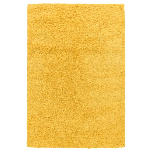 Shaggy, yellow rug - soft, durable, stain-resistant, warm, noise-reducing.