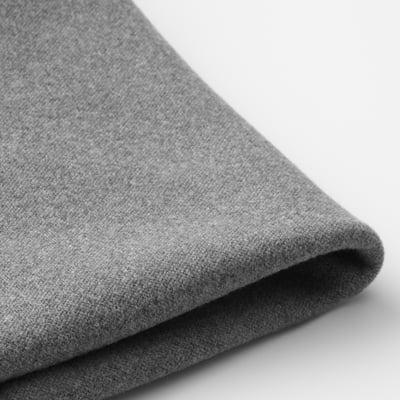 Folded grey fabric with textured surface, likely a protective chair cover, shown in close-up.