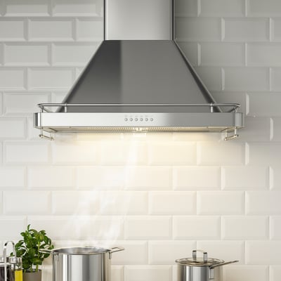 Modern kitchen extractor hood with led light, control panel, and spice rack, mounted against white tiled wall.