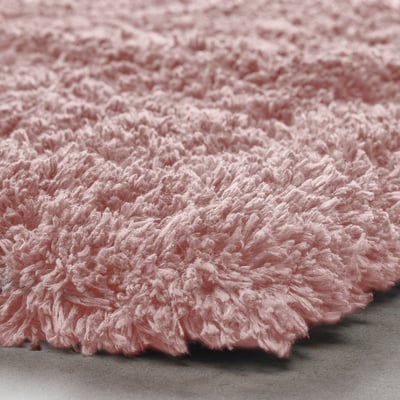 Fluffy light pink bath mat with soft microfiber, visible texture, and high pile.