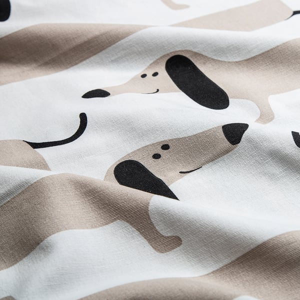 Close-up of playful dachshund print fabric, smooth cotton texture, vibrant design.
