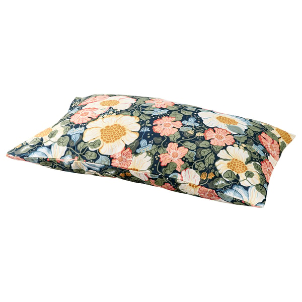 Floral pillow with peach, yellow, and green flowers on a navy background, rectangular shape, soft material.