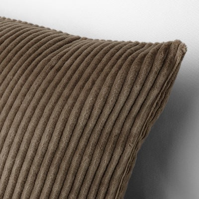 Close-up of a beige corduroy cushion pillow on a light sofa, showcasing its textured surface and hidden zip.