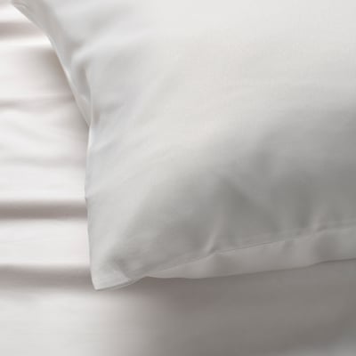 Close-up of soft, white pillowcase with smooth, brushed texture.