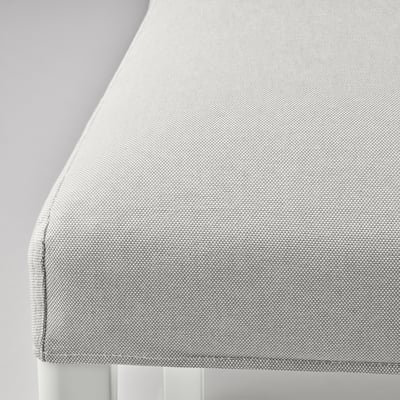 Close-up of light grey fabric upholstered chair with clean lines, showcasing its textured weave and comfortable cushion.